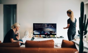 Two women watching TV in a living room