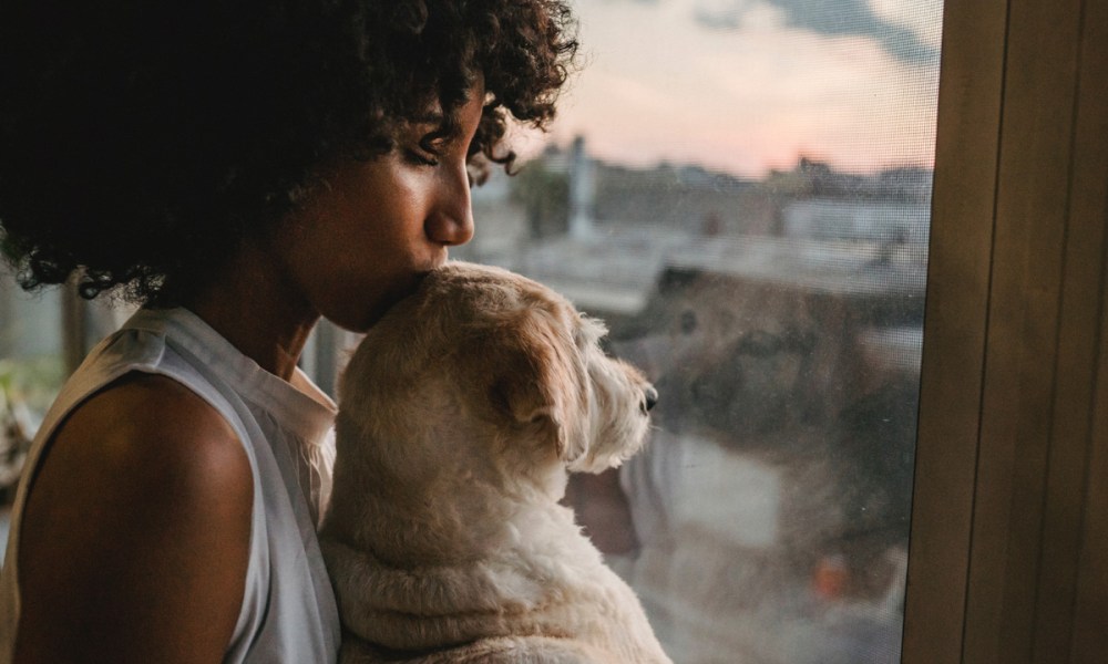 Woman kissing dog