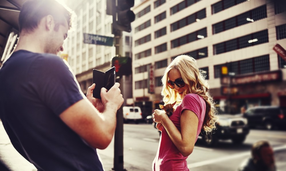 Woman holding teacup chihuahua in down town los angeles